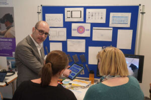 Sven Bertel erklärte sein Projekt zwei Interessierte auf der Eröffnung.